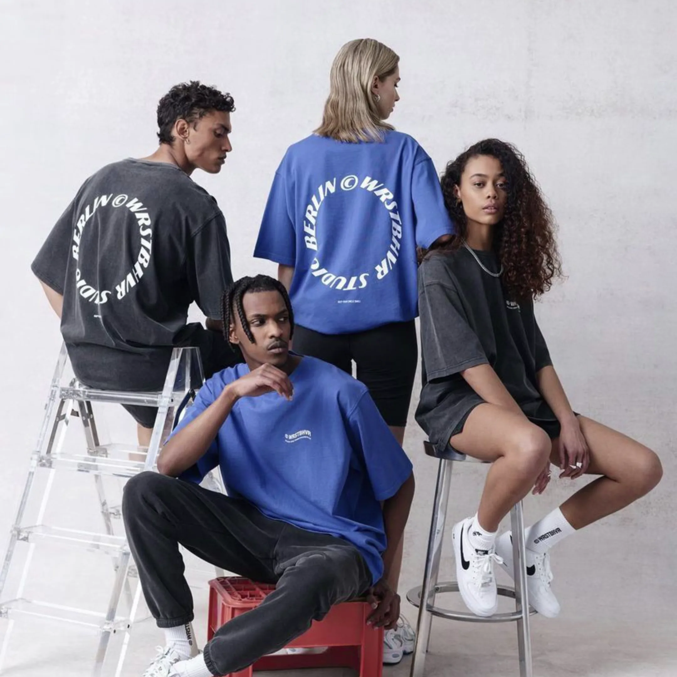 Models presenting a coordinated collection of blue and charcoal graphic T-shirts
